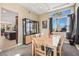 Elegant dining room with a natural wood table, designer lighting, and backyard views at 8106 Buffalo Clan Ct, Las Vegas, NV 89131