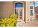 Close-up of the front entrance showing the front door and surrounding landscaping at 8106 Buffalo Clan Ct, Las Vegas, NV 89131