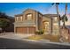 Two-story home featuring stucco, three-car garage, well-manicured yard and landscaping at 8106 Buffalo Clan Ct, Las Vegas, NV 89131