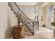 Grand foyer with a staircase, decorative molding, and a glimpse of natural light at 8106 Buffalo Clan Ct, Las Vegas, NV 89131