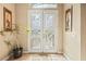 Elegant front door with decorative glass inserts, framed by artwork and a potted plant at 8106 Buffalo Clan Ct, Las Vegas, NV 89131