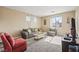 Bright living room with neutral walls, plush carpet, and a comfortable seating arrangement at 8106 Buffalo Clan Ct, Las Vegas, NV 89131