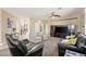 Inviting living room featuring neutral tones, plush seating, and a view into the home's entry and staircase at 8106 Buffalo Clan Ct, Las Vegas, NV 89131