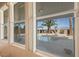 A serene view of the pool and backyard oasis, seen through a set of windows at 8106 Buffalo Clan Ct, Las Vegas, NV 89131