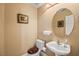 Half-bath featuring a pedestal sink, neutral wall color, and decorative mirror at 8106 Buffalo Clan Ct, Las Vegas, NV 89131