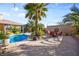 A refreshing in-ground pool in a backyard with outdoor seating and lush landscaping at 8145 Mountain Forest Ct, Las Vegas, NV 89129