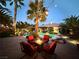 Cozy backyard patio with outdoor seating around a fire pit, overlooking the pool and lush landscaping at 8145 Mountain Forest Ct, Las Vegas, NV 89129