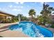 Stunning pool featuring a waterfall, tropical landscaping, and patio area for outdoor relaxation and enjoyment at 8145 Mountain Forest Ct, Las Vegas, NV 89129