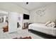 Light and airy bedroom featuring light grey floors, television, and attached bath at 8145 Mountain Forest Ct, Las Vegas, NV 89129