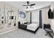 Well-lit bedroom featuring a statement mirror wall, black bed frame, and en-suite bathroom at 8145 Mountain Forest Ct, Las Vegas, NV 89129