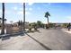 Community entrance gate with sign, mature trees, and desert landscaping at 8145 Mountain Forest Ct, Las Vegas, NV 89129