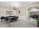 The dining room boasts an elegant chandelier, neutral colors and a view into an adjacent sitting room at 8145 Mountain Forest Ct, Las Vegas, NV 89129