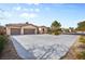 Single-story home features a three-car garage, desert landscaping, and a spacious driveway at 8145 Mountain Forest Ct, Las Vegas, NV 89129