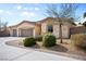 Well-maintained single-story home with a three-car garage, desert landscaping, and a curved driveway at 8145 Mountain Forest Ct, Las Vegas, NV 89129