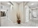 Hallway with decorative vase featuring light gray floors, archway, and adjacent rooms at 8145 Mountain Forest Ct, Las Vegas, NV 89129