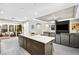 This is a well appointed kitchen with an island that has a marble counter-top and grey cabinets at 8145 Mountain Forest Ct, Las Vegas, NV 89129