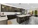 This is a view of a gorgeous kitchen featuring a marble countertop island and stainless steel appliances at 8145 Mountain Forest Ct, Las Vegas, NV 89129