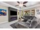 Modern living room featuring a large gray sectional, fireplace, TV, and neutral tones creating a cozy atmosphere at 8145 Mountain Forest Ct, Las Vegas, NV 89129