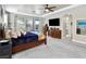 Spacious main bedroom featuring tray ceiling, large windows, and an arched entry to bathroom at 8145 Mountain Forest Ct, Las Vegas, NV 89129