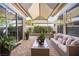 Outdoor covered patio featuring brick floor, comfortable seating, and lush plants at 8145 Mountain Forest Ct, Las Vegas, NV 89129