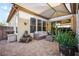 Cozy outdoor patio area with comfortable seating, potted plants and a retractable awning at 8145 Mountain Forest Ct, Las Vegas, NV 89129