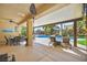 Covered patio area with a view of a sparkling pool featuring a rock waterfall feature at 8145 Mountain Forest Ct, Las Vegas, NV 89129