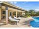 The covered patio adjoins the pool with lounge chairs for enjoying the sunny outdoors at 8145 Mountain Forest Ct, Las Vegas, NV 89129