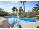 Backyard pool featuring an in-pool umbrella and a rock waterfall feature at 8145 Mountain Forest Ct, Las Vegas, NV 89129