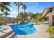 Backyard featuring a private pool with palm trees, waterfall feature and lounge chairs on the patio at 8145 Mountain Forest Ct, Las Vegas, NV 89129