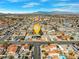 Expansive aerial view of neighborhood with the home centrally located, showcasing a desirable location near mountain views at 8212 Ducharme Ave, Las Vegas, NV 89145