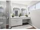 Bathroom featuring double sinks, bright vanity lighting, and wood-look floors at 8212 Ducharme Ave, Las Vegas, NV 89145