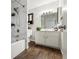 Bathroom featuring wood-look flooring, a shower/tub combo, and a white vanity at 8212 Ducharme Ave, Las Vegas, NV 89145