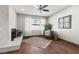 Cozy living room featuring a stone fireplace and wood flooring at 8212 Ducharme Ave, Las Vegas, NV 89145