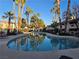 Community pool surrounded by palm trees and lounge chairs provides a relaxing space for residents at 8455 W Sahara Ave # 258, Las Vegas, NV 89117