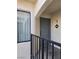 A condo entrance with a gray door and a dark metal railing at 8455 W Sahara Ave # 258, Las Vegas, NV 89117