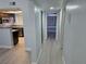 Hallway view leading to a modern kitchen with stainless steel appliances and a bright window at 8455 W Sahara Ave # 258, Las Vegas, NV 89117