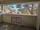 View from the patio shows a decorative wall and attractive condo buildings in a community with mature trees at 8455 W Sahara Ave # 258, Las Vegas, NV 89117