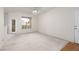 Bright living room featuring neutral carpet, ceiling fan, and a glass-paneled door at 9000 Las Vegas Blvd # 1245, Las Vegas, NV 89123