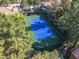 Aerial view of a community tennis court surrounded by mature landscaping at 9000 Las Vegas Blvd # 1245, Las Vegas, NV 89123