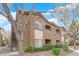 Condo exterior with brown stucco, tile roof, second story entrances and mature trees at 9000 Las Vegas Blvd # 2138, Las Vegas, NV 89123