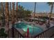 Aerial view of the backyard featuring a swimming pool, lounge chairs, and well-maintained landscaping at 9012 Alpine Peaks Ave, Las Vegas, NV 89147