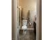 Cozy bathroom with tiled floors, a toilet, vanity with granite top, and a shower with glass door at 9012 Alpine Peaks Ave, Las Vegas, NV 89147