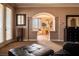 A large leather ottoman sits in front of an archway leading to the Primary bathroom at 9012 Alpine Peaks Ave, Las Vegas, NV 89147