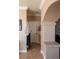 Archway view of a bathroom featuring a long vanity with dual sinks and framed mirror at 9012 Alpine Peaks Ave, Las Vegas, NV 89147