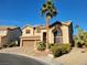 Charming two-story home with a tile roof, lush landscaping, and a well-maintained lawn at 9012 Alpine Peaks Ave, Las Vegas, NV 89147