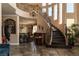 Elegant foyer with a curved staircase and wrought iron detailing at 9012 Alpine Peaks Ave, Las Vegas, NV 89147