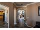 Spacious hallway with tiled floors, neutral paint, decorative archways, and views to the living areas at 9012 Alpine Peaks Ave, Las Vegas, NV 89147