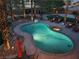 Aerial view of a backyard pool and spa with rock landscaping and lounge seating area at 9012 Alpine Peaks Ave, Las Vegas, NV 89147