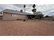 Large backyard with desert landscaping and a covered patio area at 904 Dianne Dr, Boulder City, NV 89005