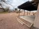 Large backyard with desert landscaping, block wall, and covered patio area at 904 Dianne Dr, Boulder City, NV 89005